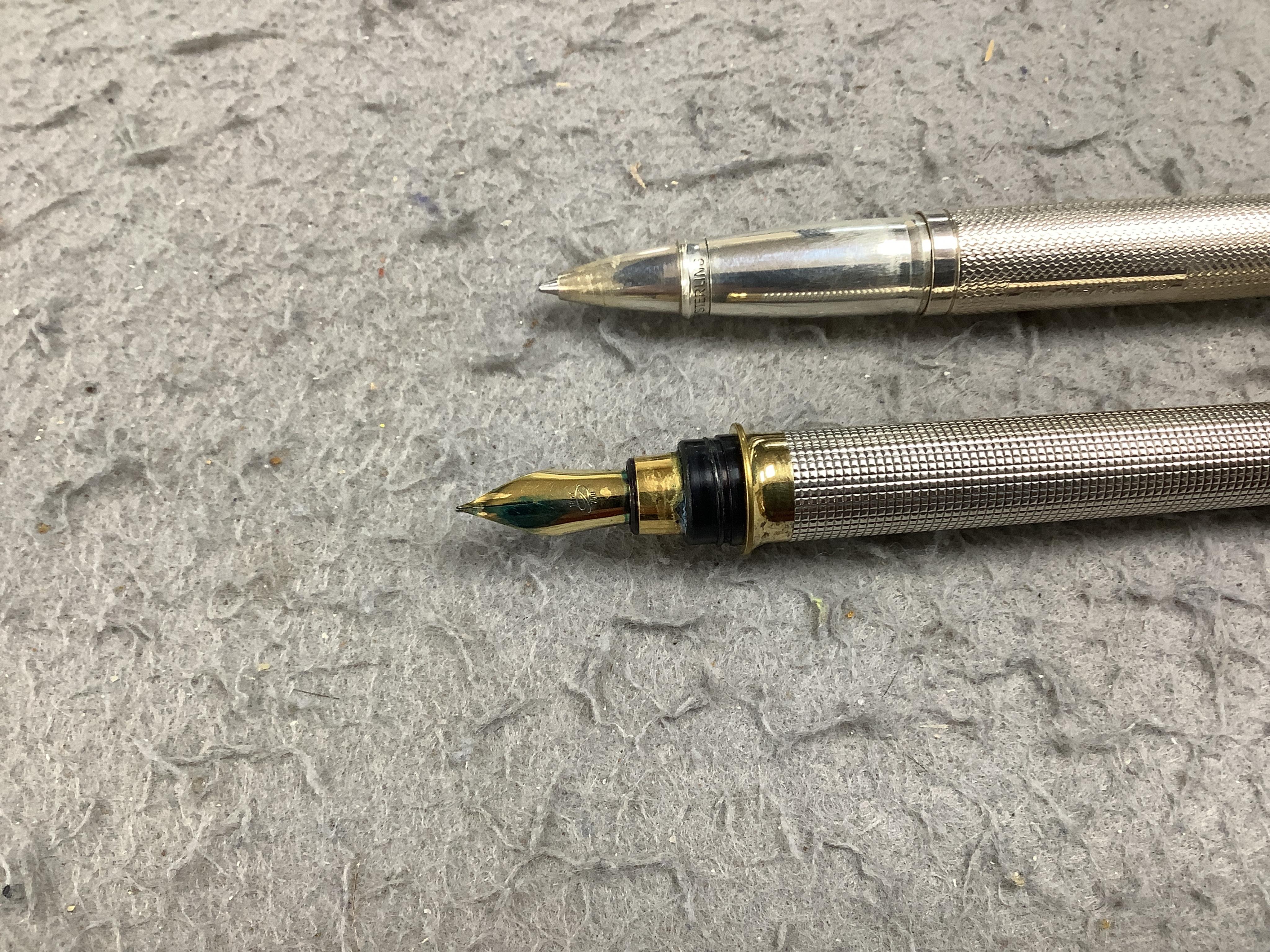 A collection of pens comprising two Sterling Parker fountain pens, one with 14k gold nib, a silver Yard-O-Lead pen, a lizard skin wallet and a Dupont fountain pen. Condition - wallet worn, pens not tested with ink for wo